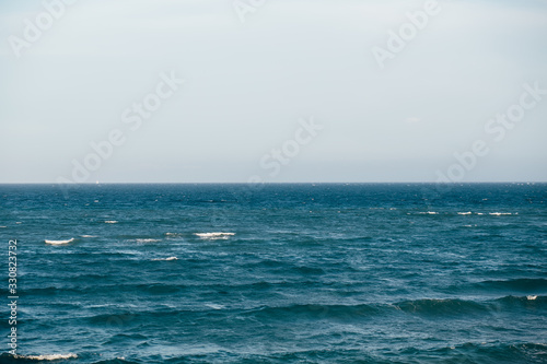 Blue sea with waves and cloudy sky background. Seascape background for design.