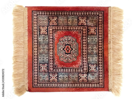 Фотография Elegant small red persian rug with fringe isolated on white background