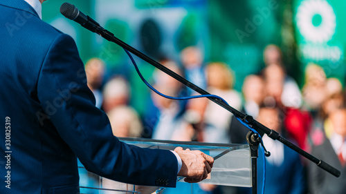 Election campaign, politician on stage, speaking to the crowd