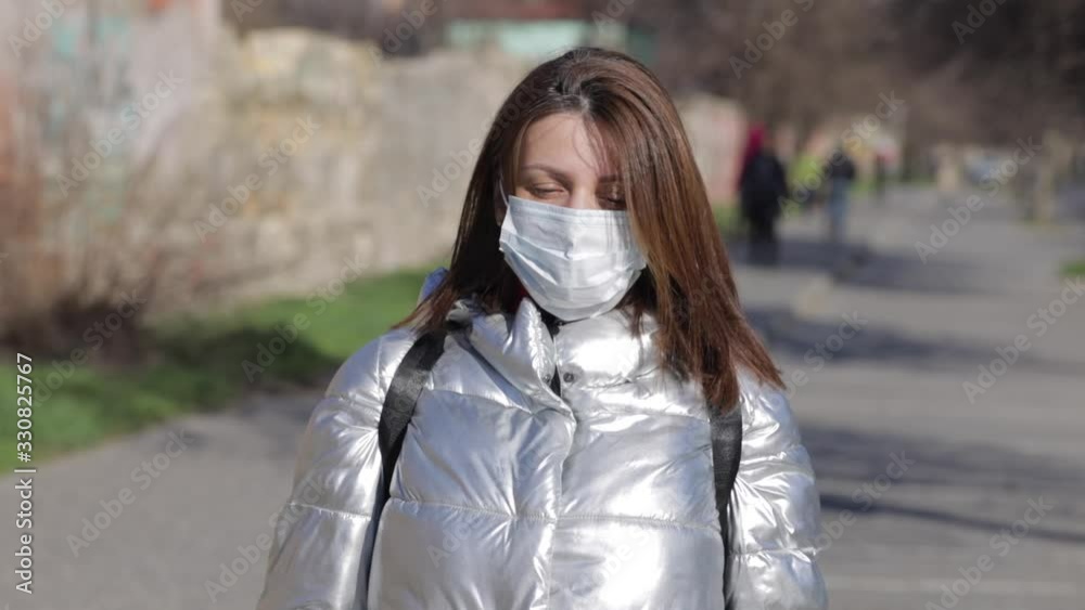 Girl puts on a mask in a public place. Girl puts on a mask in a public place.