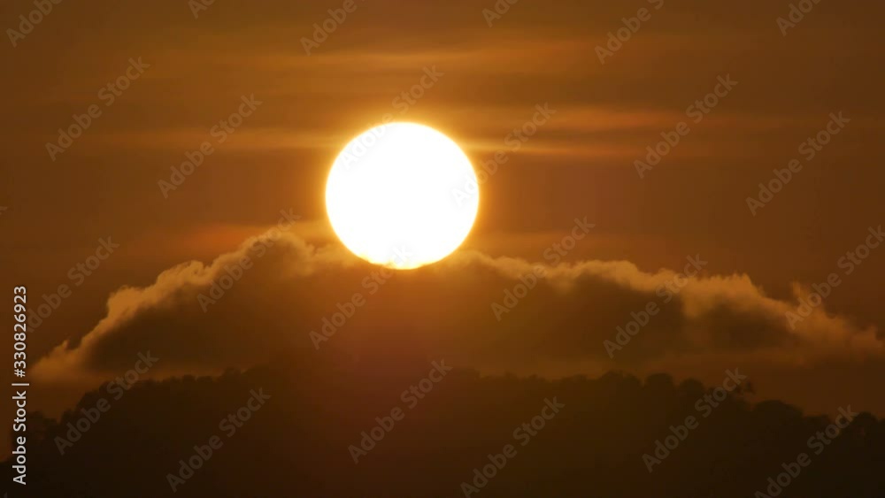 hue sunset over  silhouette Phuket big buddha statue on hilltop with many big trees high mountain in the beautiful evening colourful  orange twilight sky,moving cloud,  attraction tourist photo spot