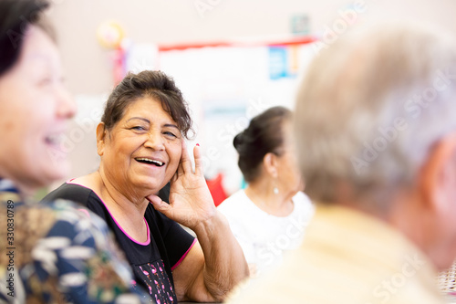 Smiling Hispanic Woman in a Senior Activity Center photo