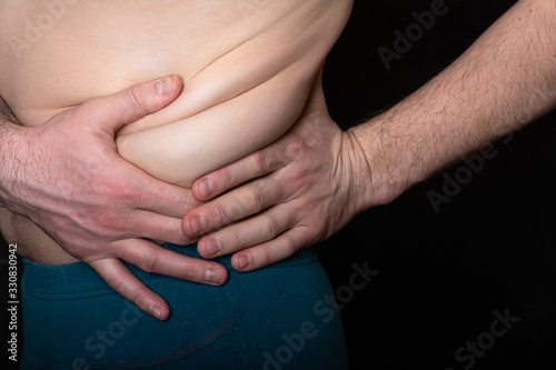 Wallpaper Mural male bare torso. hands compresses problematic folds with excess fat in the lateral area. health concept, unhealthy diet, poor diet Torontodigital.ca