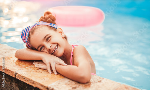 Joyful little girl in swimming pool