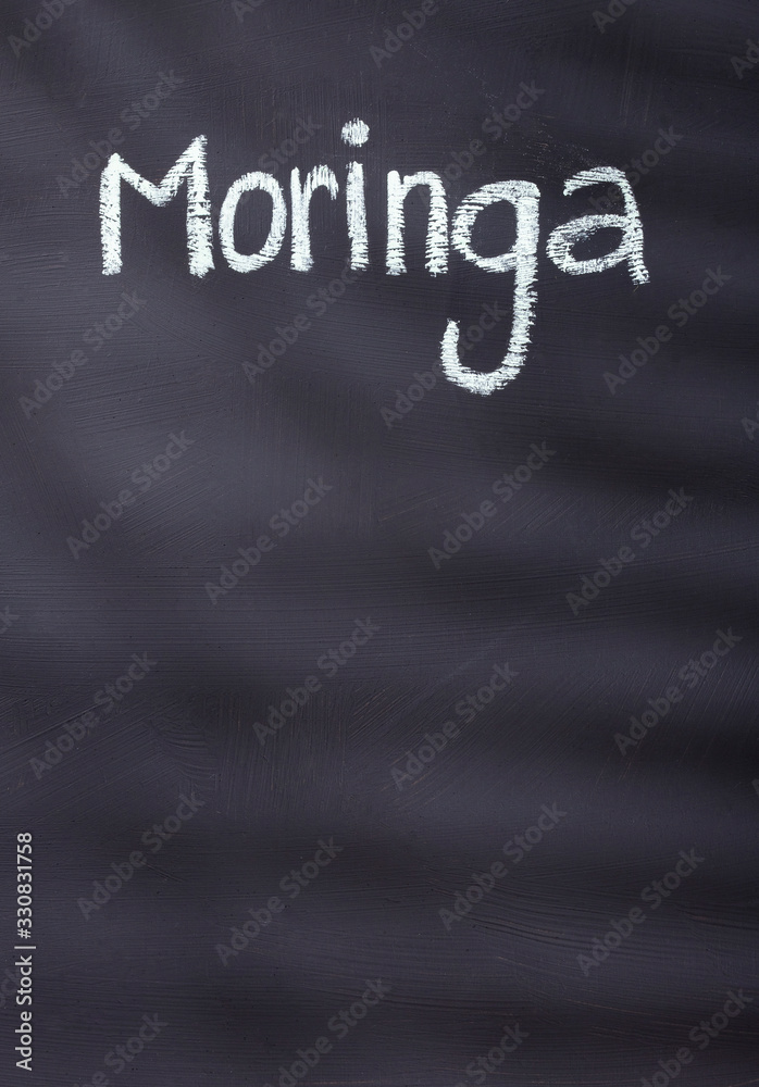 Obraz premium Moringa written with chalk on rustic background - Moringa oleifera