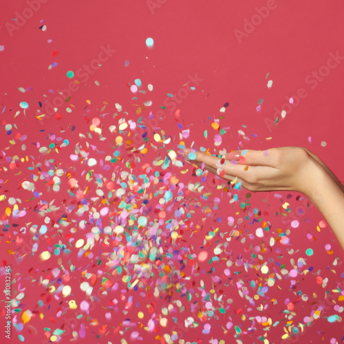 Birthday party holiday background with colorful confetti on pink