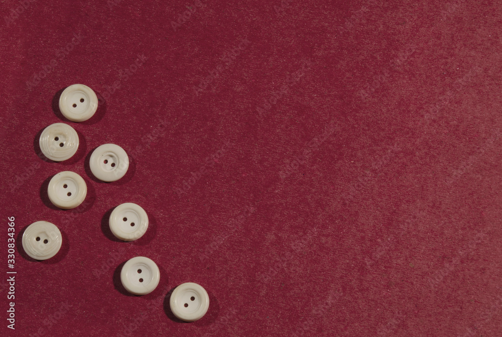 Many white buttons on a red background. Many white buttons on a red background.