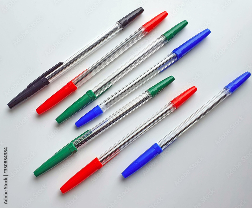 Set of plastic ballpoint pens of different colors with a plastic cover, isolated on a white background, stationery Set of plastic ballpoint pens of different colors with a plastic cover, isolated on a white background, stationery