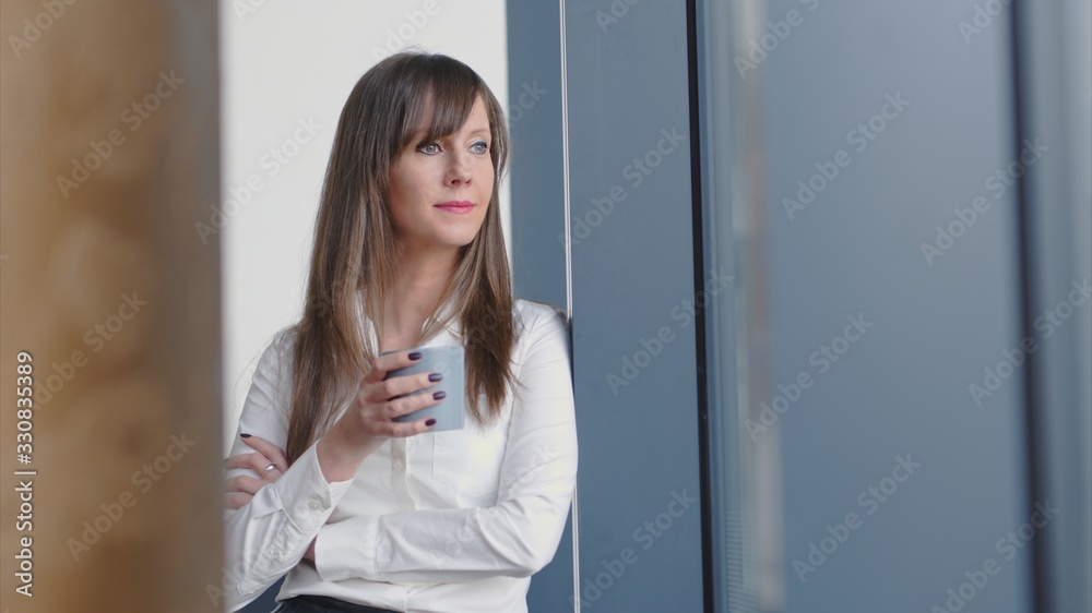 Businesswoman in office drinking coffee Businesswoman in office drinking coffee