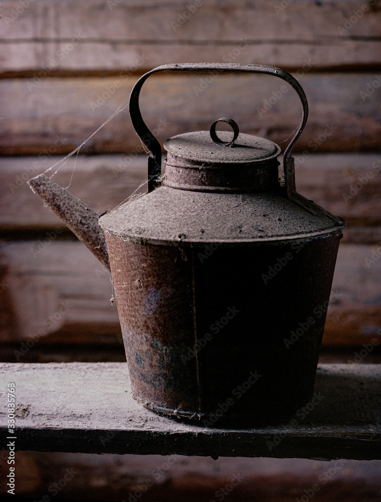 old rusty coffee pot with cobwebs against timbered wall old rusty coffee pot with cobwebs against timbered wall