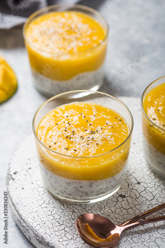 Chia seed pudding with mango in glass jars. Clean eating, healthy vegan vegetarian food concept