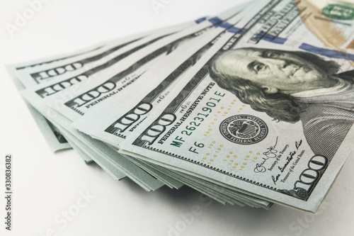 Stack of american money, one hundred dollar cash banknotes on white background, lot of one hundred dollar bills