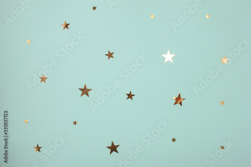 Pattern of golden stars on mint background