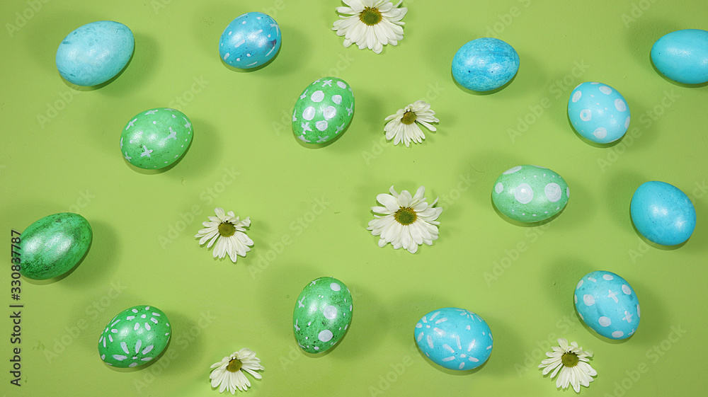 Decorated golden and blue eggs on a trendy green background. Minimal holiday concept. Happy Easter background, pattern, greeting card, banner for the screen. Decorated golden and blue eggs on a trendy green background. Minimal holiday concept. Happy Easter background, pattern, greeting card, banner for the screen.