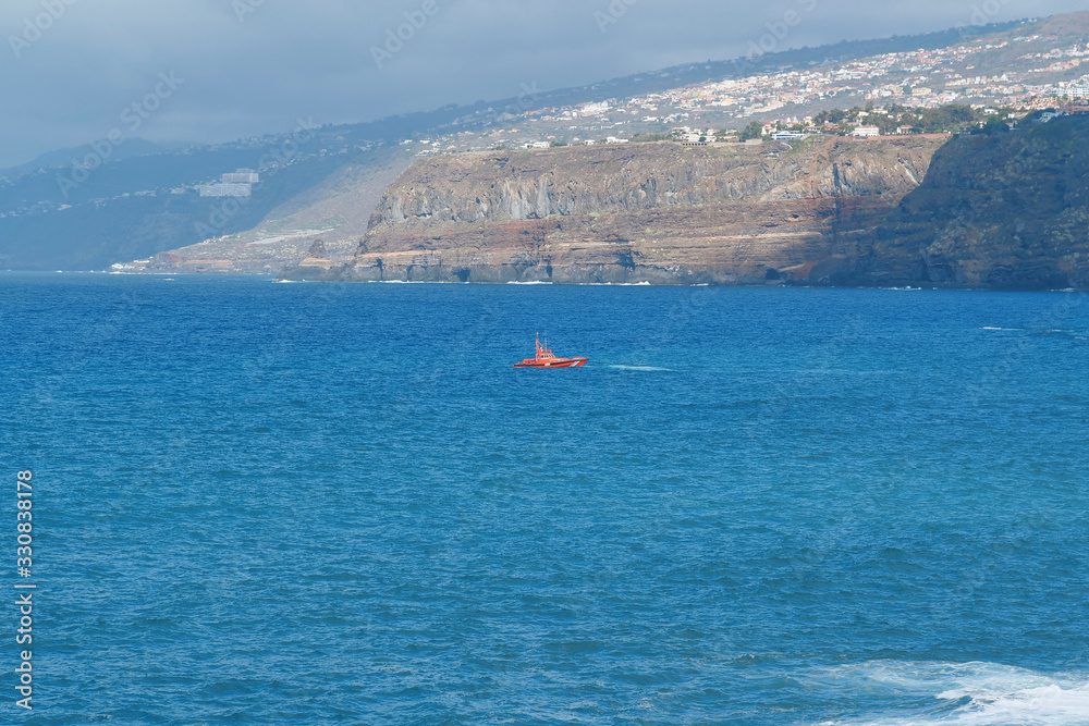 Red lifeboat in Atlantic ocean near Puerto de la Cruz, Tenerife island