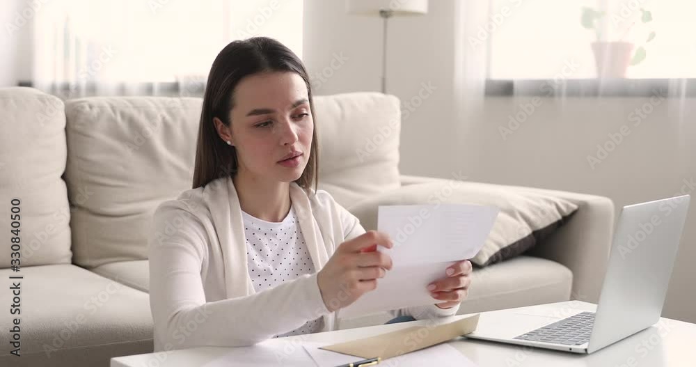 Excited young woman reading good news in letter at home. Overjoyed girl opening envelope receiving admission. Happy female student winner checking correspondence get scholarship or great exam results. Excited young woman reading good news in letter at home. Overjoyed girl opening envelope receiving admission. Happy female student winner checking correspondence get scholarship or great exam results.
