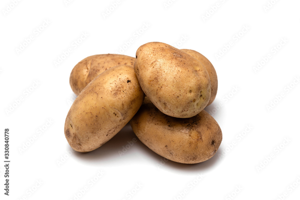 raw dirty potatoes on a white background raw dirty potatoes on a white background