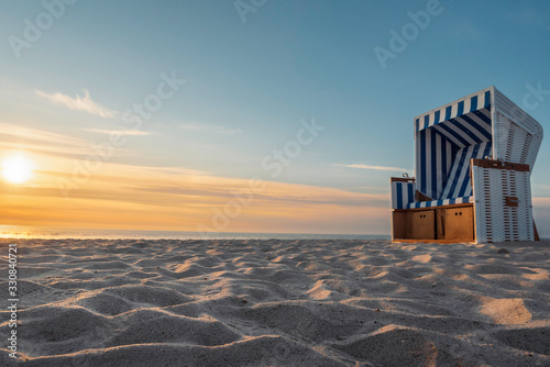 White sand beach and wicker chair on Sylt island photo