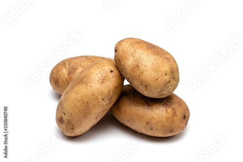 raw dirty potatoes on a white background