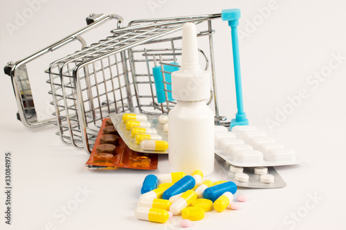 White nose spray. Pills in shopping cart. The pills spilled out of the supermarket cart.