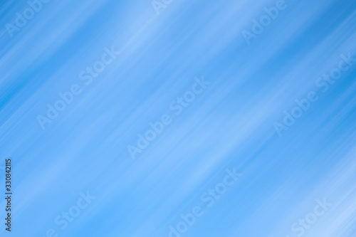 Clouds in motion. Sky background with diagonal blur lines.The abstract pastel soft colorful smooth texture. Blue and white colors of light tones.