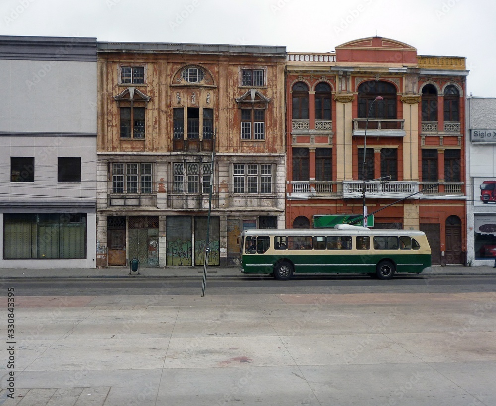Old facades with trolleybus in valparaiso chile