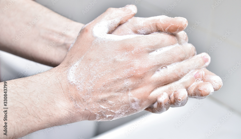 Man washes his hands with soap. Individual hygiene and protection Man washes his hands with soap. Individual hygiene and protection