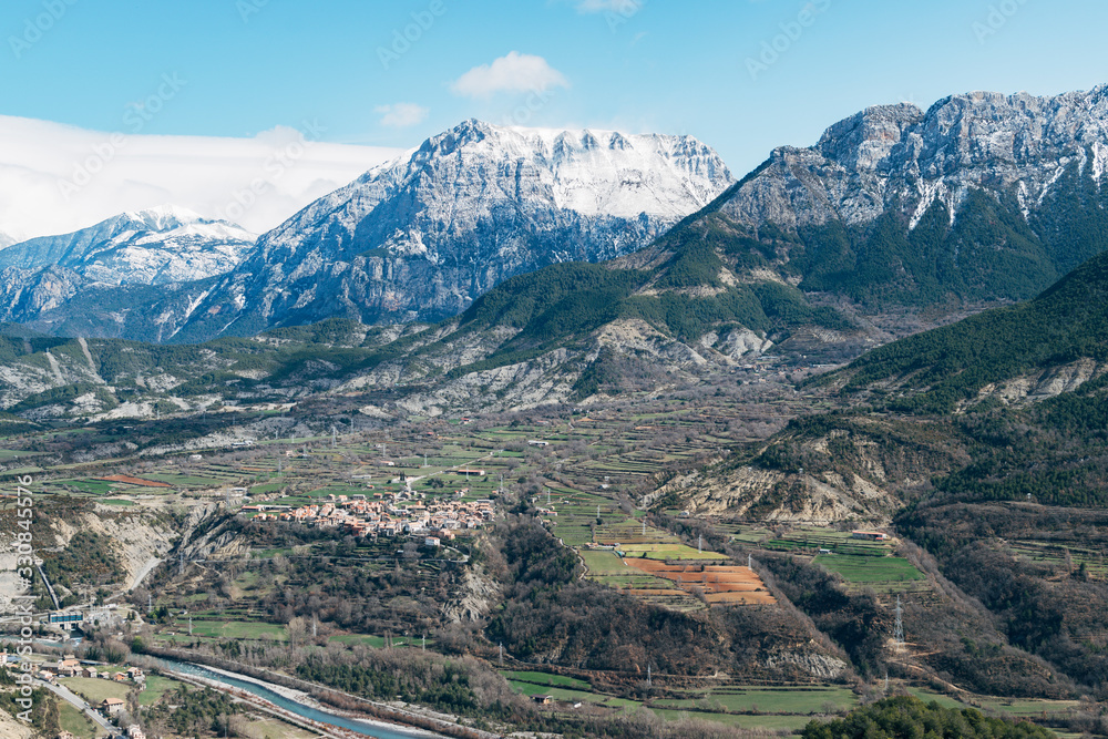 Photograph of set of snowy mountains in a valley.