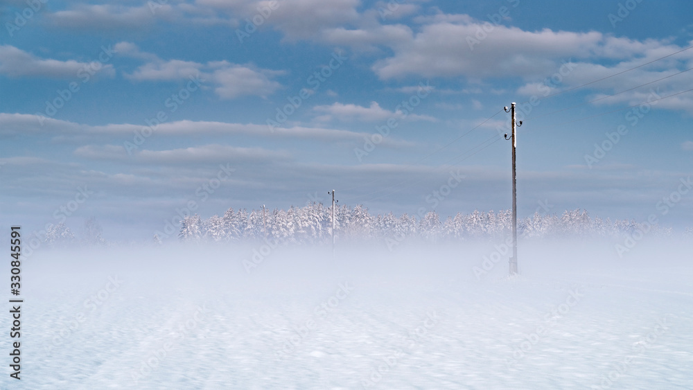 Winter sunrise over snow covered field with a layer of fog. Winter sunrise over snow covered field with a layer of fog.