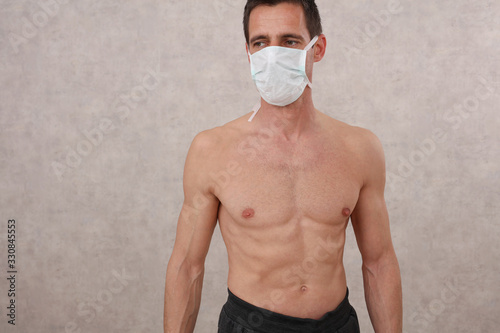 Sport man wearing hygienic medical mask during workout . Self-isolation and self-quarantine, Coronavirus Prevention