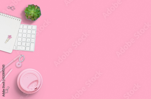 Flat layout of workplace. Succulent, cup of coffee and empty notepad on pink background