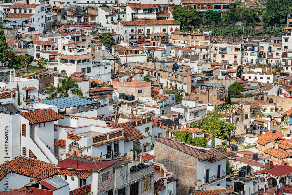 Scenic view of Taxco, Mexico. Overview of dense buildings on steep hills of colonial town of Taxco