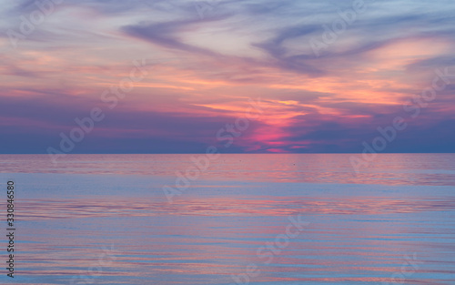 Pink sunset on the sea. Twilight Dusk. Beautiful clouds over the calm sea. © Anna Pismenskova