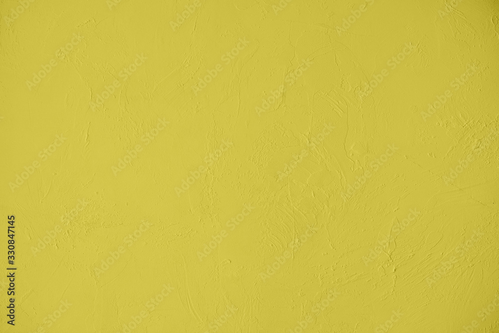 Saturated yellow colored low contrast Concrete textured background with roughness and irregularities. 2020, 2021 color trend.