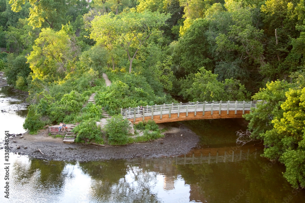 Footbridge spanning the backwaters of the Mississippi River. Father Hennepin Bluffs Park Minneapolis Minnesota MN USA