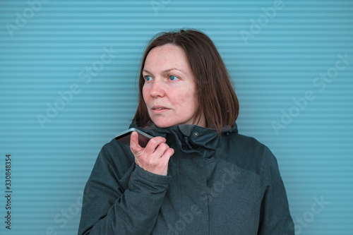 Casual woman using mobile phone for communication outdoors photo