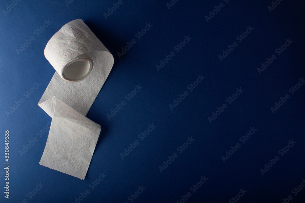 Toilet paper on a blue background top view. The concept of deficit and crisis. Coronavirus and epidemic virus. Horizontal orientation. The view from the top. Copy space. Space for text