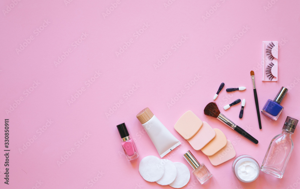 Professional makeup tools. Makeup tools brushes, eyelashes, nail polish, ,cotton pads, applicators on pink background. Cosmetics for beauty. Top view with copy space Flat lay. Professional makeup tools. Makeup tools brushes, eyelashes, nail polish, ,cotton pads, applicators on pink background. Cosmetics for beauty. Top view with copy space Flat lay.