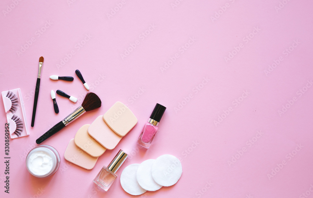 Professional makeup tools. Makeup tools brushes, eyelashes, nail polish, ,cotton pads, applicators on pink background. Cosmetics for beauty. Top view with copy space Flat lay. Professional makeup tools. Makeup tools brushes, eyelashes, nail polish, ,cotton pads, applicators on pink background. Cosmetics for beauty. Top view with copy space Flat lay.