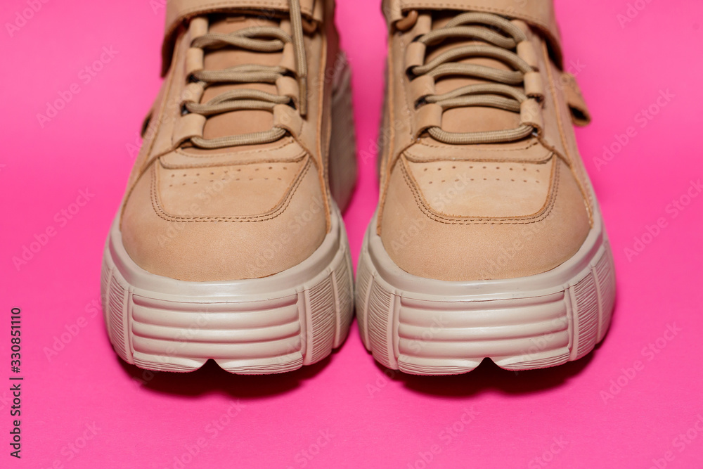 brown leather women shoes with high soles on a pink background. fashion footwear brown leather women shoes with high soles on a pink background. fashion footwear