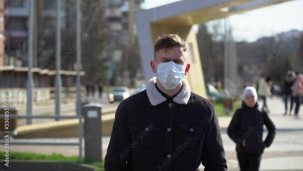 Young guy in protective mask. Concept of protection against the global pandemic of the coronavirus, virus protection. Pandemic, Coronavirus (2019-nCoV). Health and safety, virus protection Young guy in protective mask. Concept of protection against the global pandemic of the coronavirus, virus protection. Pandemic, Coronavirus (2019-nCoV). Health and safety, virus protection