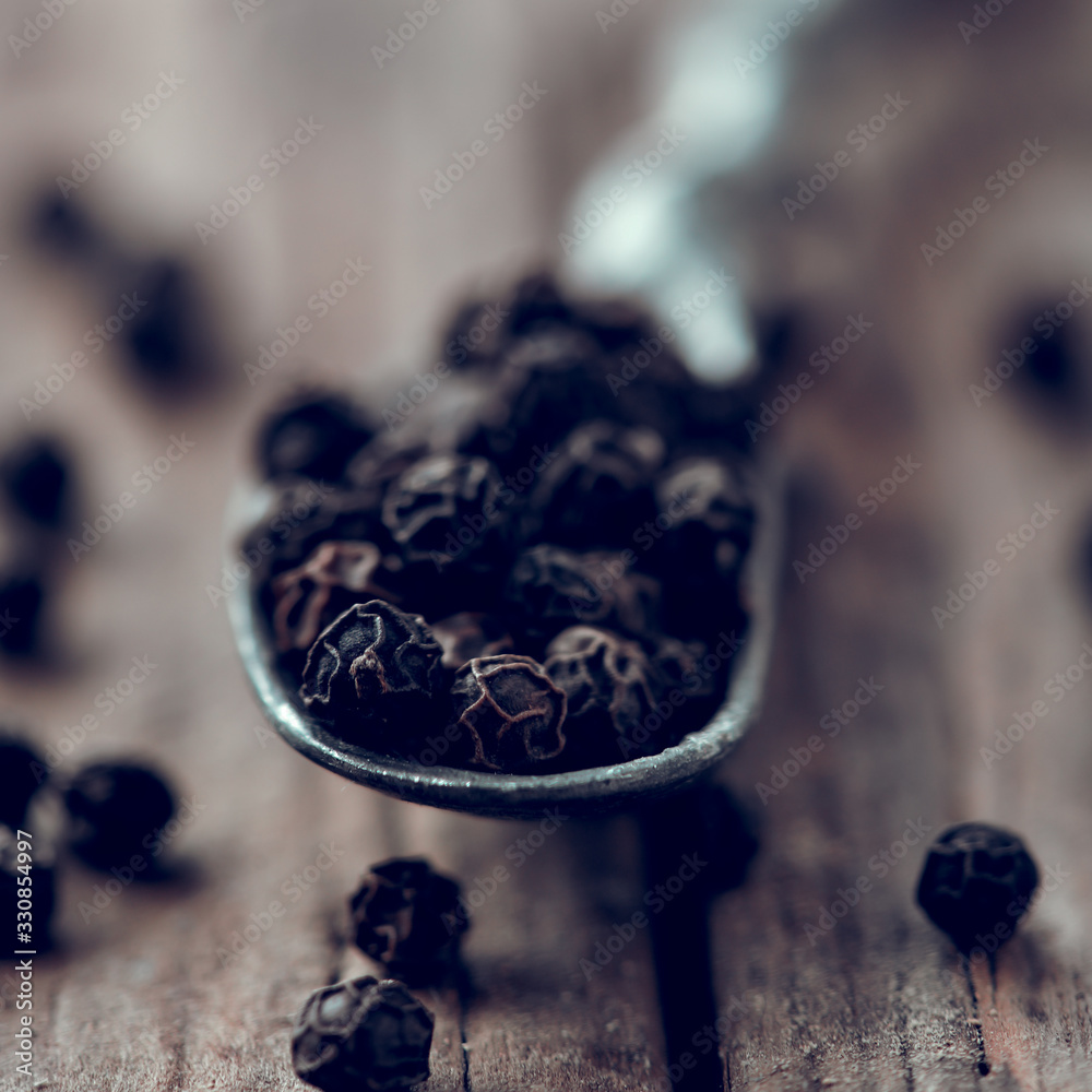Black pepper on wooden background.Soft selective focus. Black pepper on wooden background.Soft selective focus.