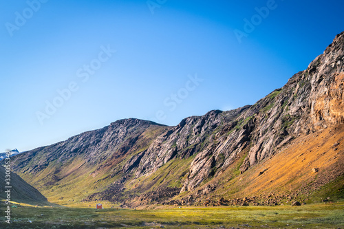 Shelter hidden in a valley lit by sun