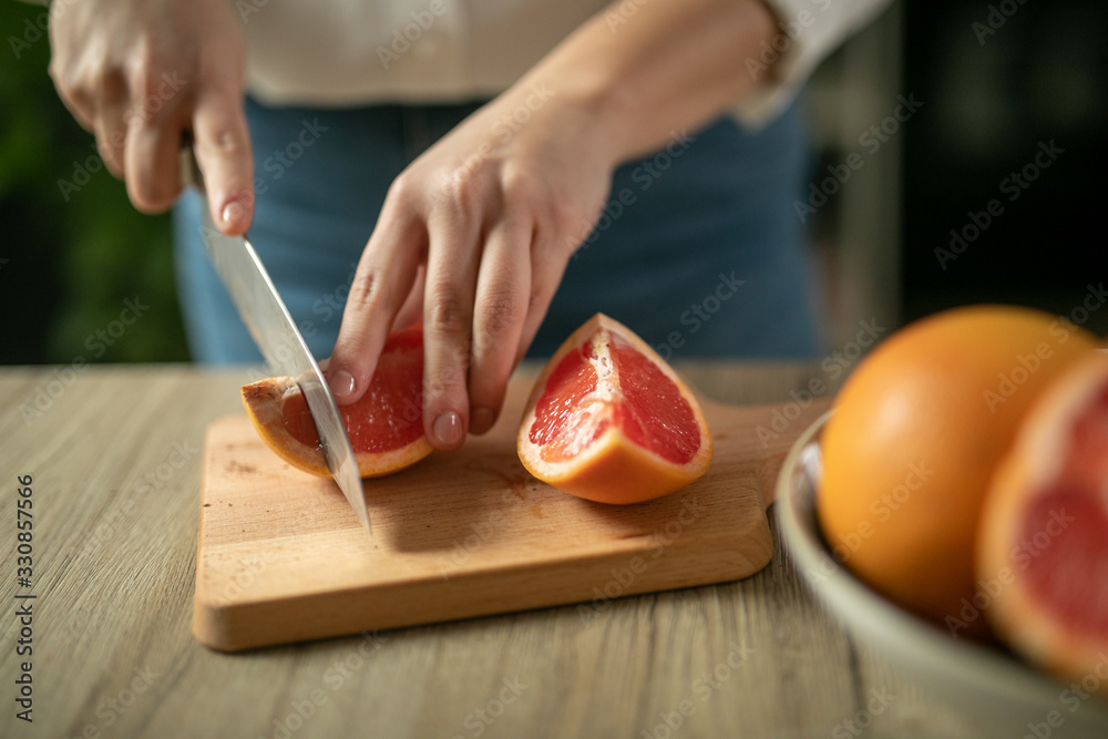 shot of woman cutting orange shot of woman cutting orange