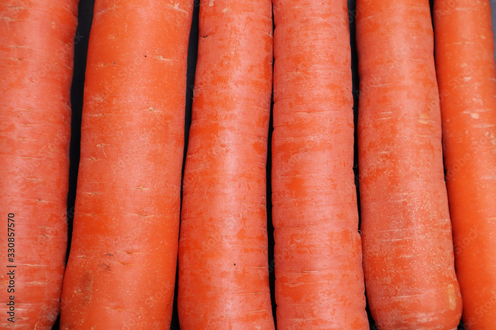 Ripe carrots on a black textured background. Ripe carrots on a black textured background.