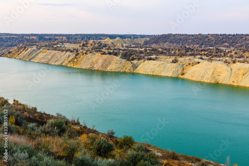 Lake with sandy bank in the abandoned coal quarry