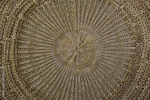 Close-up on a knitted beige thing. The circular texture. The trend for natural materials. Perfect background