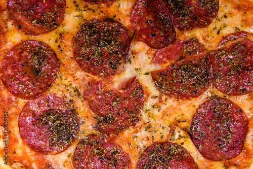 Background of the pizza with salami sausage and parmesan cheese