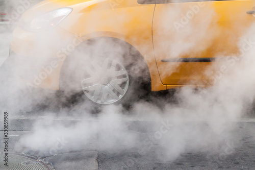 New York City taxi with smoke pouring out of street