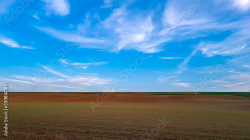 sunset over a field with blue sky in countryside